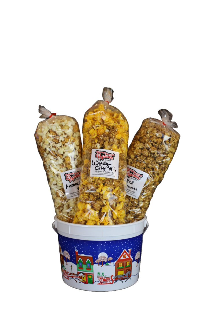 Picture of the Caramel Confection 3-Pack of Gourmet Popcorn in a Holiday-Themed Bucket